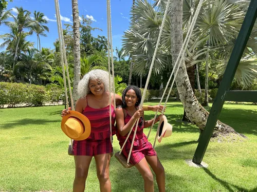 Tami and her daughter on a swing in matching outfits